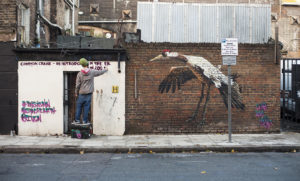 Street artist Louis Masai paints the Common Crane in Camden, London 14.11.14 as part of a campaign by the IUCN and Synchronicity Earth to raise greater consciousness about human impact on UK animals